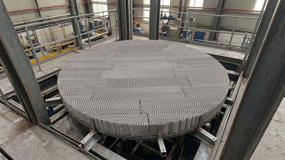 304 stainless steel Pall rings loaded into a distillation column with camel hump support grid at bottom