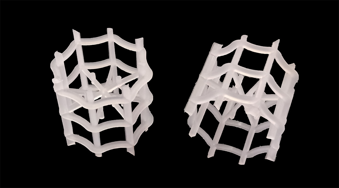 Close-up of single plastic VSP ring showing alternating inner arc folds and hollow cross-section