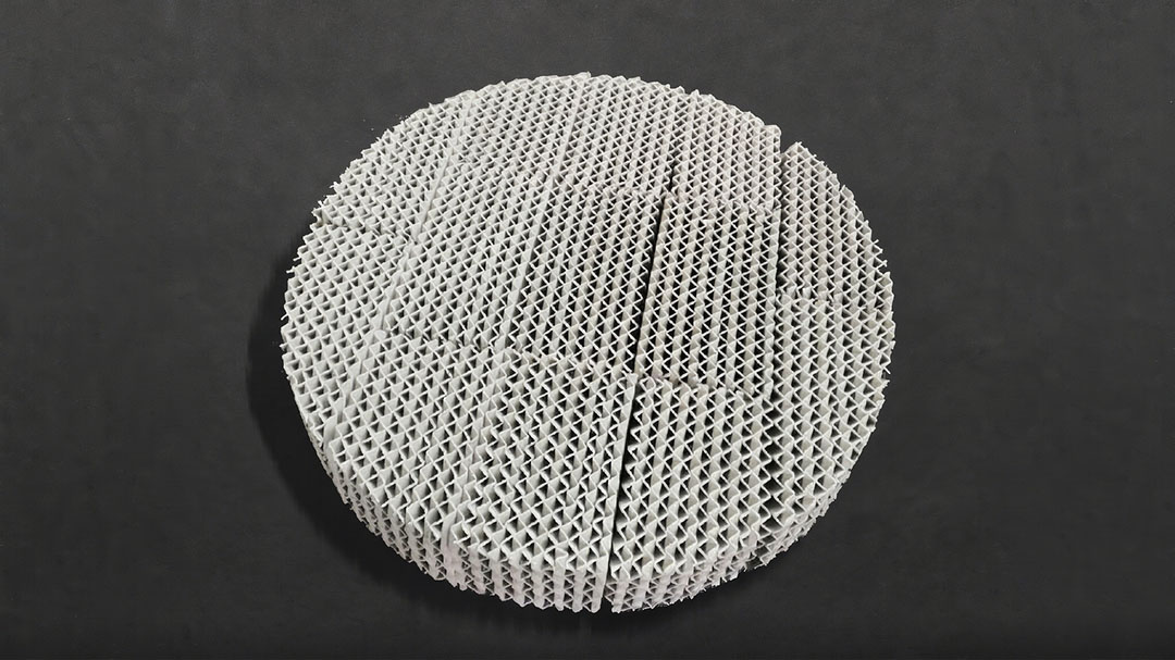 Ceramic structured packing modules stacked on reinforced support grid inside high-temperature column